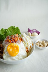 instant rice bowl beef with indonesian sambal matah , egg and onion closeup in a bowl on the table.