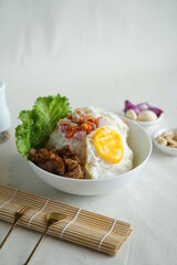 instant rice bowl beef with indonesian sambal matah , egg and onion closeup in a bowl on the table.