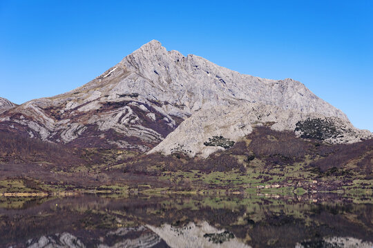 View since the Viewpoint of the porma reservoir, in the province of leon, on a sunny day with the Susar&oacute;n peak and mountains reflected in the water of the reservoir. Castilla y Leon, Spain.