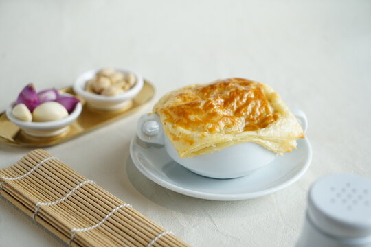 Grainy homemade creamy soup dish with corn potage and crisp puff pastry. Known as Zuppa Soup in Indonesia