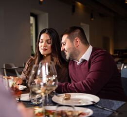 Happy couple Laughing at Dinner Table
