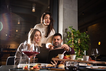 Group of Happy friends having dinner in the restaurant