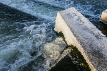 Water Cascading over Weir Step in river canal.