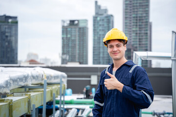 The engineer is inspecting the cooling tower air conditioner in a large industrial building to...