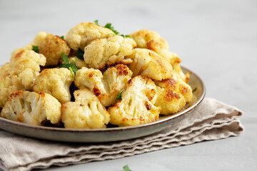 Homemade Roasted White Cauliflower on a Plate, side view.