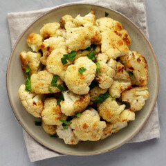 Homemade Roasted White Cauliflower on a Plate, top view. Flat lay, overhead, from above.