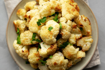 Homemade Roasted White Cauliflower on a Plate, top view. Flat lay, overhead, from above. Close-up.