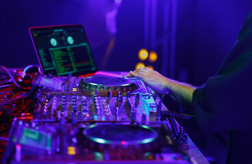 Club DJ playing music set on party. Disc jockey mixing musical tracks with sound mixer and cd...