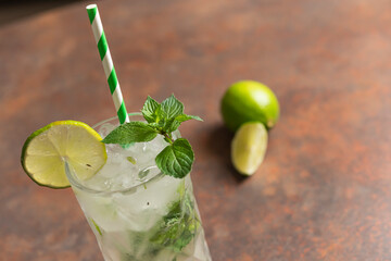 Lemon juice with mint leaves in a glass on a wooden surface