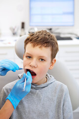 Kid in a dental clinic. Orthodontic treatment. Children's dentistry, Pediatric Dentistry. A boy in braces on his teeth at a dentist's appointment.