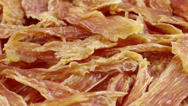 Brown dried chicken breast jerky meat circle rotation close up