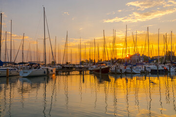 Sailing ships in the harbour of Balatonkenese at sunset