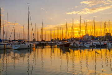 Fototapeta na wymiar Sailing ships in the harbour of Balatonkenese at sunset
