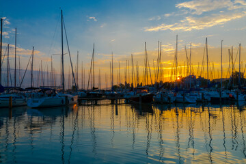 Sailing ships in the harbour of Balatonkenese at sunset