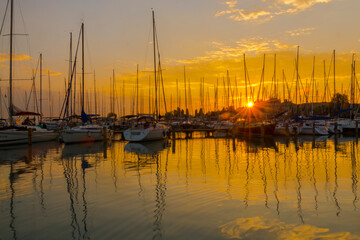 Sailing ships in the harbour of Balatonkenese at sunset