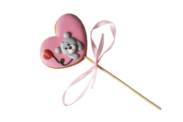 Gingerbread in the shape of a heart with a a teddy bear  on a wooden stick with a bow .  Romantic cookies. Isolate on white. PNG