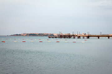 Seascape, early summer mornings and people in the distance meet dawn on pier