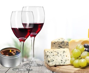 Tasty fresh cheese with berries and wine glasses
