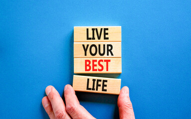 Live your best life symbol. Concept words Live your best life on wooden blocks. Beautiful blue table blue background. Businessman hand. Business live your best life concept. Copy space.