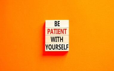 Patient with yourself symbol. Concept words Be patient with yourself on wooden blocks. Beautiful orange table orange background. Business patient with yourself concept. Copy space.