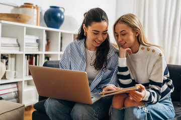 Two friends study together at home