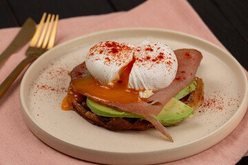 Poached egg with avocado on a waffle