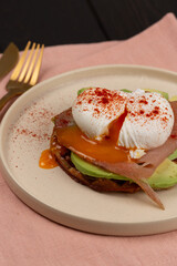 Poached egg with avocado on a waffle