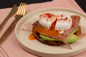 Poached egg with avocado on a waffle