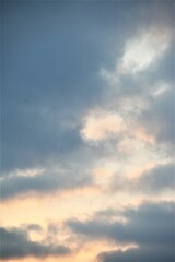 Cloudy sky with blue clouds, cloudy weather, blue, yellow, pink, white color, as background