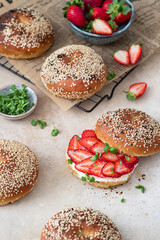 Breakfast bagel sandwich with cream cheese and strawberries