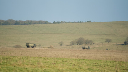 Fototapeta na wymiar British army MAN SV 4x4 green logistics lorries in action in countryside