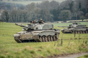 close-up of two British army FV4034 Challenger 2 ii main battle tanks in action on a military combat exercise, Wiltshire UK