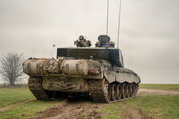 close-up rear three-quarter view of a British army FV4034 Challenger 2 ii main battle tank in action on a military combat exercise, Wiltshire UK