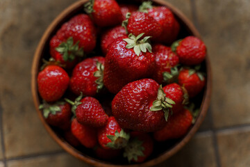 Fresh strawberries in a wooden bowl. Selective focus.