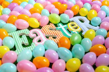 Colorful plastic eggs and a wooden Ester letters