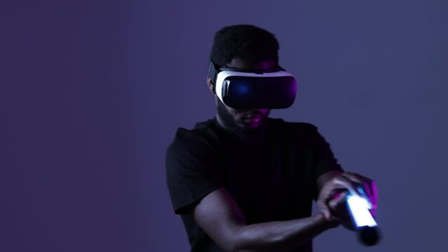 African American guy in Smart glasses of virtual reality. Augmented reality game, future technology, AI concept. VR. Neon light.