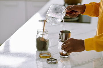 Woman Pouring Water in Phin Filter