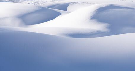 Naklejka na ściany i meble Snow mounds and snowdrifts on sunny winter day. Abstract snowy background