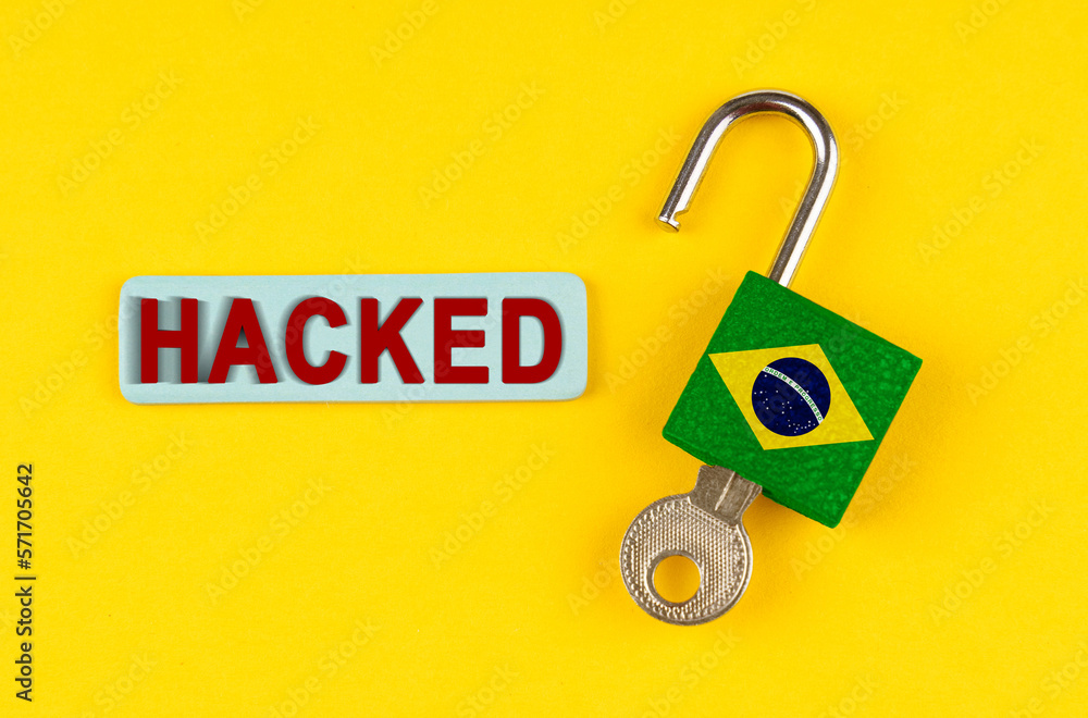 Poster on the yellow surface is an open lock with a key and a sticker with the inscription - hacked