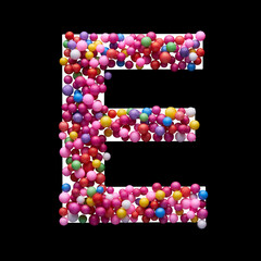 Capital letter E made of multi-colored balls, isolated on a black background.