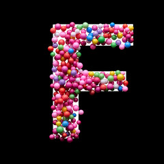Capital letter F made of multi-colored balls, isolated on a black background.