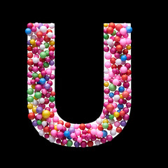 Capital letter U made of multi-colored balls, isolated on a black background.