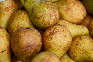 close-up of a pile of ripe yellow pears on the market