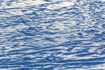 Tracks on the white snow in the sunlight.