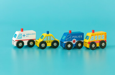 Wood sings: police, ambulance, taxi, and school bus on blue background isolated. Symbols: wood toys for kids.