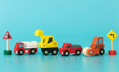 Wood sings: construction truck with traffic signs on blue background isolated. Symbols: wood toy for kids.