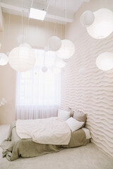 White bedroom interior. Stylish cozy interior of contemporary room with comfortable bed