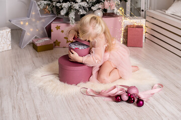 Magical moment of holiday cheer as a child unwraps Christmas presents in a dreamy setting.