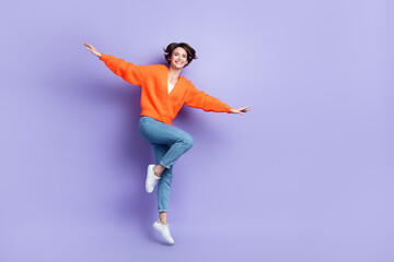 Full body size cadre of youngster careless satisfied lady jumping flying wings hands model brand...