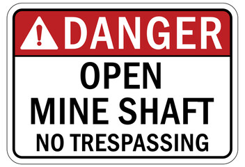 Active mine site warning sign and labels open shaft no trespassing